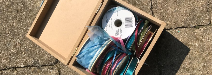Photograph of a box of ribbon rolls