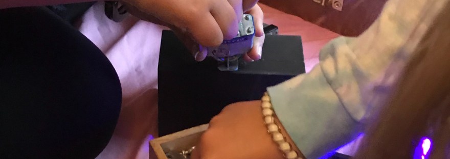 Photograph of team hunting for key to open puzzle box