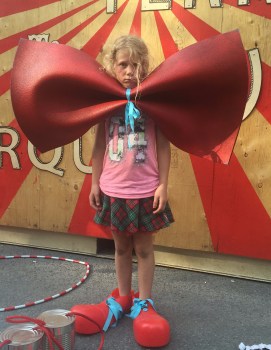 Photograph of a sad girl dressed as a clown