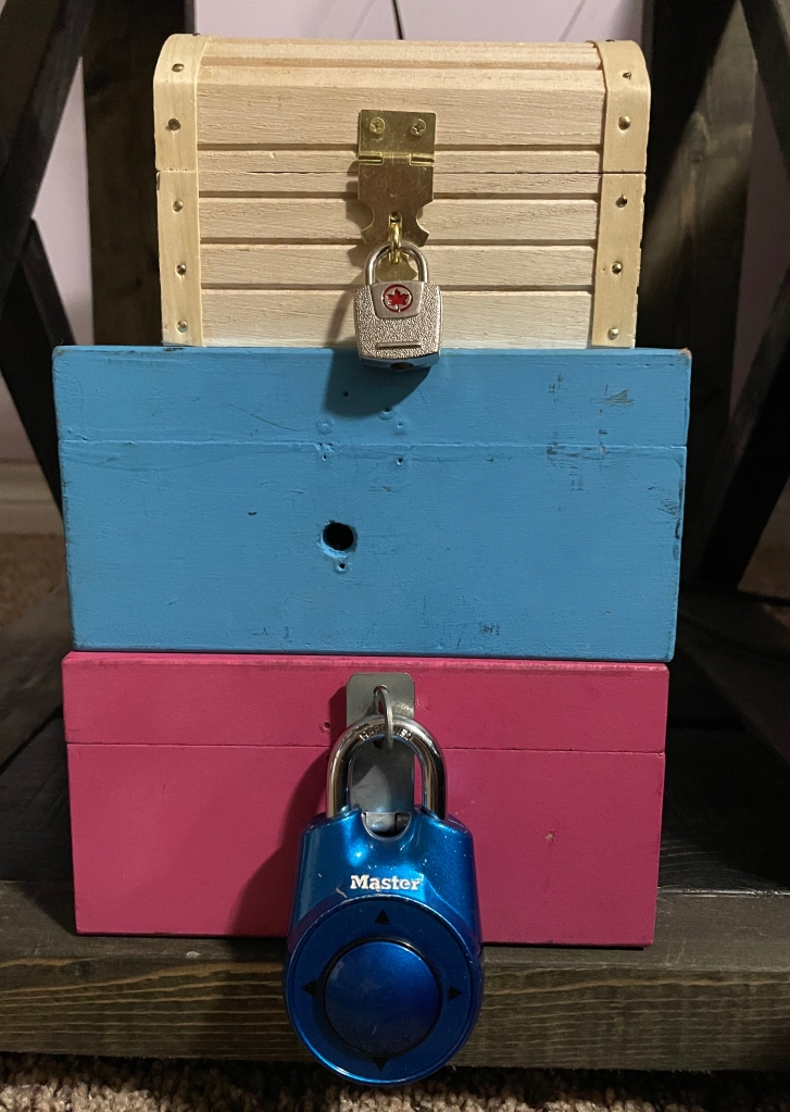 Stack of coloured wooden boxes with locks
